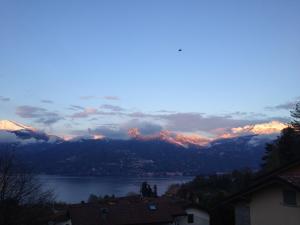 a view of a lake and snow capped mountains at Hotel Adler in Menaggio