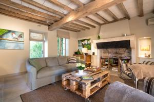 a living room with a couch and a coffee table at Le Clos du Verger in Levernois