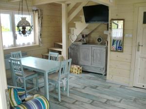 a kitchen and dining room with a table and chairs at Lawendowa Dolina in Ustroń