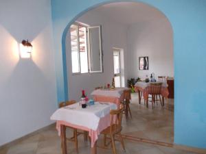 a dining room with tables and chairs and a window at B&B Porta di Suso Camerota in Camerota