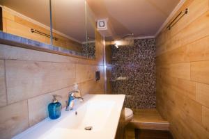 a bathroom with a white sink and a toilet at Gonis Suites in Palaiochóra +33 photos