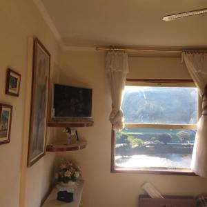 Μια τηλεόραση ή/και κέντρο ψυχαγωγίας στο Apartamento Cavalinho Branco 501