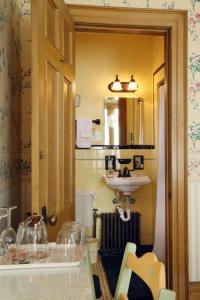 a bathroom with a sink and a toilet at Barrister's Bed & Breakfast in Seneca Falls