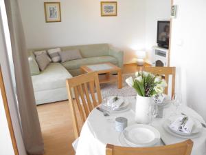 a living room with a table and a couch at Apartment Adria in Trogir +25 photos