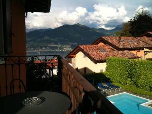 a balcony with a table and a swimming pool at Hotel Adler in Menaggio