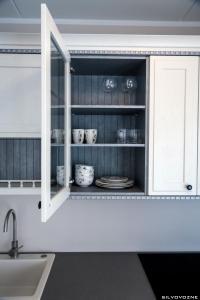 a kitchen with white cabinets and a sink at Tähe Apartment in Tartu