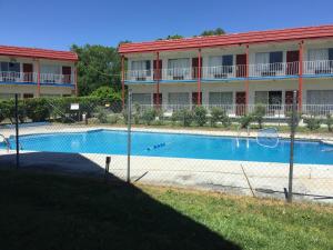 a large swimming pool in front of a building at Flagship Inn in Petersburg