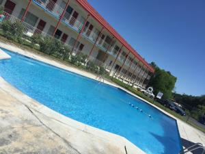 a large blue swimming pool in front of a building at Flagship Inn in Petersburg +16 photos
