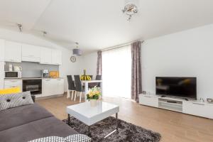 a living room with a couch and a table at Panorama Holidays in Kaštela