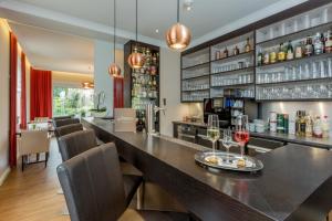 a bar in a restaurant with glasses of wine at Landhotel Bartmann in Sendenhorst