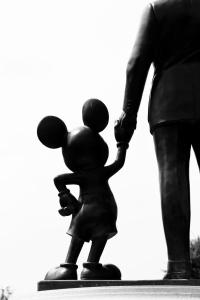 a statue of a child holding a balloon at Cortona Inn and Suites Anaheim Resort in Anaheim