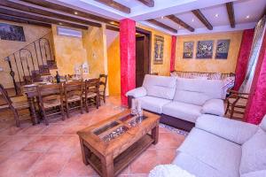 a living room with a couch and a table at Casa Valle del Genal in Igualeja