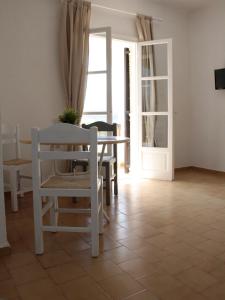 a dining room with a table and chairs and a door at Pella in Istron in Istro