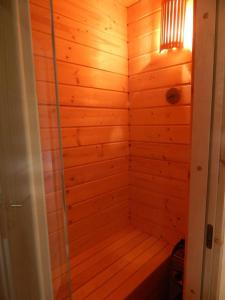 a wooden bathroom with a shower in a room at Laganini in Samobor