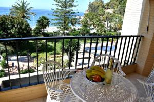 a table with bananas and a bowl of fruit on a balcony at Rosa Nautica 301 in La Herradura