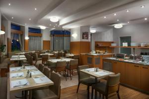 a restaurant with tables and chairs in a room at Astoria Hotel in Prague