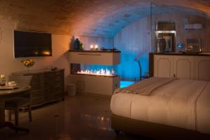 a bedroom with a bed and a fireplace at Hotel Don Ferrante in Monopoli