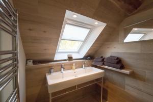 a bathroom with a sink and a window at Le Clos du Verger in Levernois +21 photos