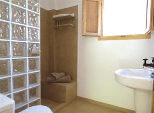 a bathroom with a sink and a toilet and a mirror at Cortijo Solera in Soportújar