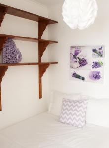 a bedroom with a white bed and a pendant light at Origens Hostel in Sines