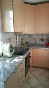 a kitchen with a counter top with a toaster oven at Mattoni Nel Verde in Casal Palocco
