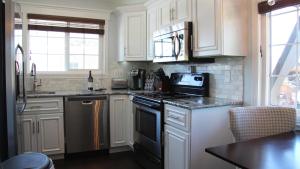 a kitchen with white cabinets and a black stove top oven at The New Yorker in Whitefish