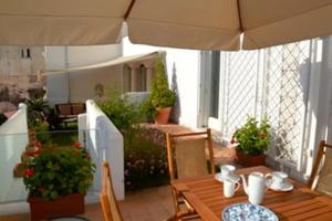 a patio with a table and chairs and an umbrella at Villa Valeria in Ravello