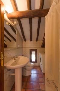 a bathroom with a sink and a toilet at Casa Trallero in Almazorre +54 photos