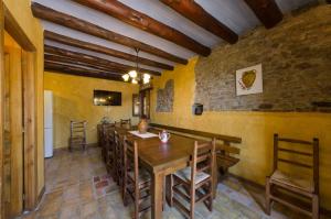 a dining room with a wooden table and chairs at Casa Trallero in Almazorre