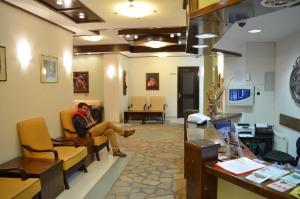 a man sitting on a couch in a waiting room at KOP Centar Aviator in Kopaonik