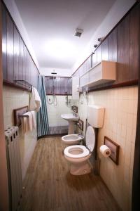 a bathroom with two toilets and a sink at Albergo Livorno in Casciana Terme