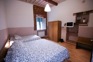 a bedroom with a white bed and a window at Albergo Livorno in Casciana Terme