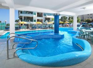 a large swimming pool with a blue water slide at Hotel Majestic in Gabicce Mare