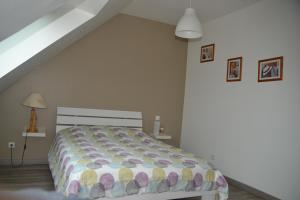 a bedroom with a bed in a attic at Les Carcahutes in Audresselles