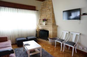 a living room with a couch and a fireplace at Aloka rooms Sopela in Sopelana