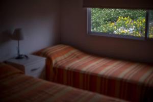 Una cama o camas en una habitación de El Faro Apart