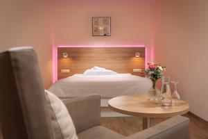 a bedroom with a bed and a table with a vase of flowers at Erkheimer Landhaus in Erkheim