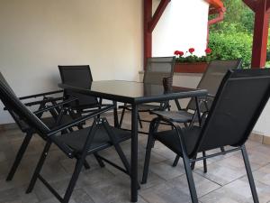 a black table and chairs on a patio at Arborétum in Harkány