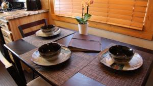 a table with two cups and plates on top of it at Cowboy Condo in Whitefish