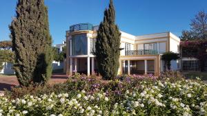 a house with a garden in front of it at Villa Bouganvilia - Casa da Vigia in Albufeira