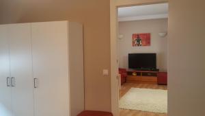 an open door to a living room with a television at Pension Yna Holiday in Málaga