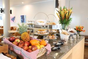 a buffet with fruit in baskets on a counter at Mantra Club Croc in Airlie Beach