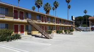 a building with a staircase in a parking lot at Economy Inn Motel in Sylmar