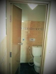 a bathroom with a white toilet in a room at Hotel Srikandi Baru in Yogyakarta