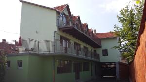 a building with balconies on the side of it at Pensiunea Casa Szabi in Luna de Sus