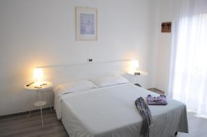 Postel nebo postele na pokoji v ubytování Hotel Cecile