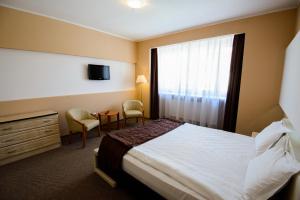 Un pat sau paturi într-o cameră la Residence Piata Sfatului