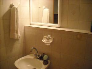 a bathroom with a sink and a mirror and towels at Level Houses in Kefalos
