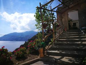 a set of stairs next to a building with flowers at Badia Santa Maria de' Olearia in Maiori