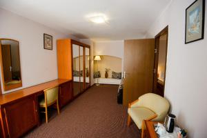 Un pat sau paturi într-o cameră la Residence Piata Sfatului